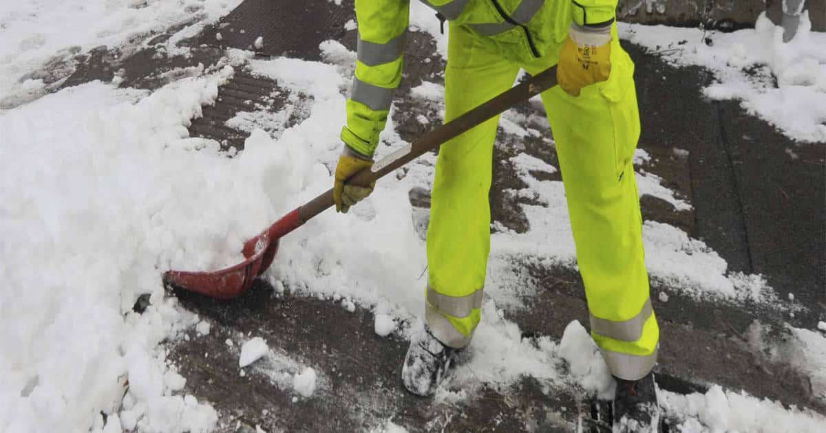 Seasonal Worker Shoveling Snow